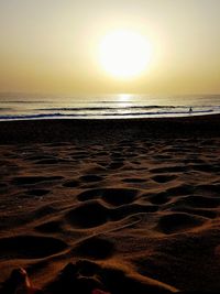 Scenic view of beach against sky during sunset