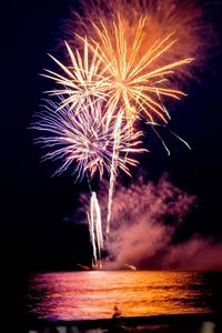 Low angle view of firework display at night