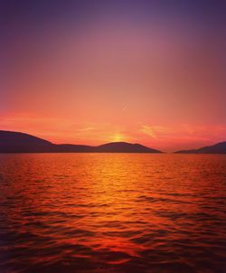 Scenic view of sea against romantic sky at sunset