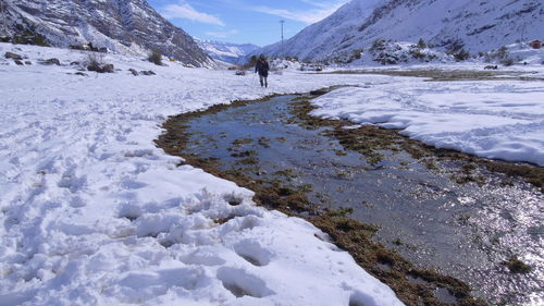 People walking on snow covered mountain