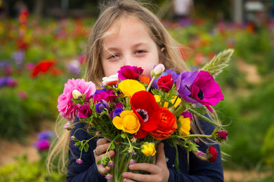 Portrait of girl holding colorful flowers