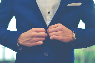 Midsection of man wearing blazer