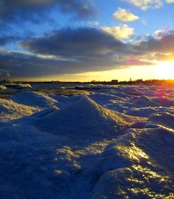 Scenic view of snow covered landscape at sunset