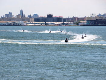 Scenic view of sea by city against sky