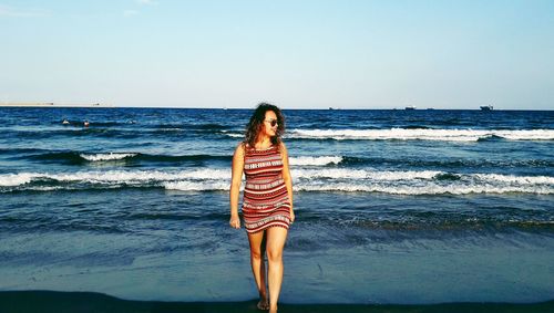 Rear view of woman standing on beach