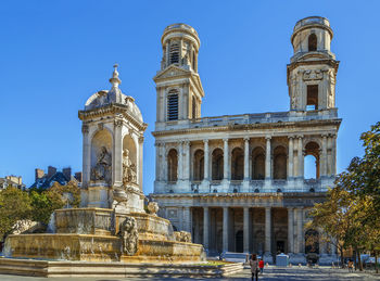 Statue of historic building against blue sky