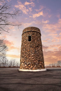 Sunset over tall cobblestone structure of scargo tower in dennis, cape cod, massachusetts