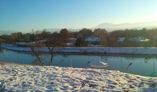 Scenic view of lake against sky during winter