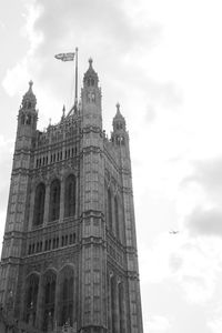 Low angle view of building against cloudy sky