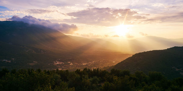 Scenic view of mountains against sky at sunset