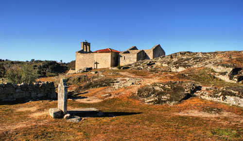 Old ruin building against blue sky