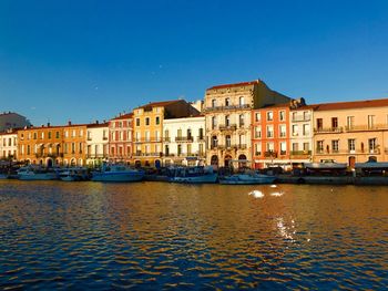 Boats in canal along buildings