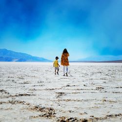 Rear view of women walking on land