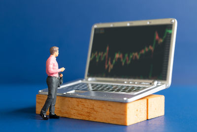 Full length of man using laptop on table