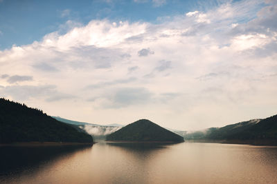 Scenic view of lake and mountains against sky