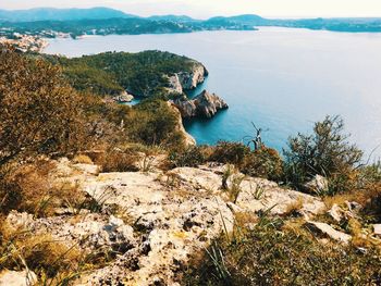 High angle view of rocks and sea against sky