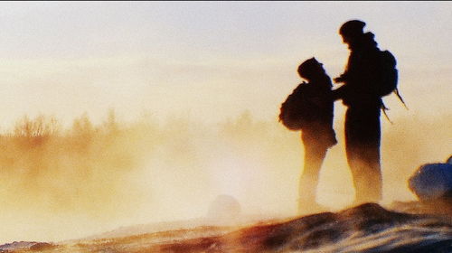 People on beach against sky during sunset