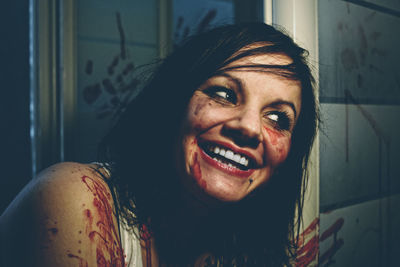 Close-up of smiling criminal with blood on face