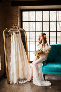 Redhead bride in dress holding wedding bouquet and smiling. wedding day concept