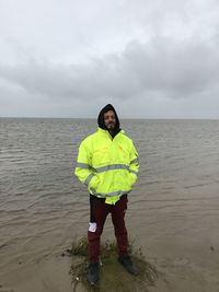 Full length of man standing by sea against sky