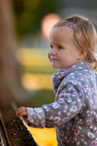 Close-up of cute girl standing outdoors