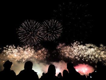 Low angle view of firework display at night