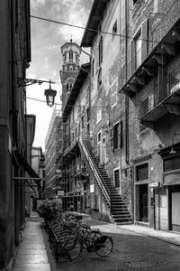 Footpath amidst buildings in city