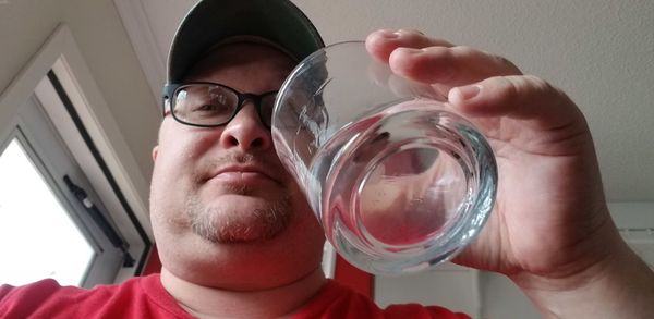 Portrait of man drinking glass