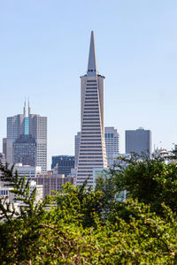 Buildings in city against clear sky