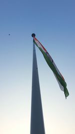 Low angle view of flag against clear sky