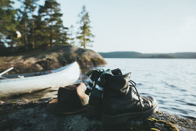 High angle view of shoes by sea against clear sky