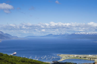 High angle view of townscape by sea against sky