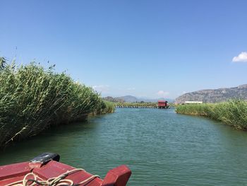 Scenic view of river against cloudy sky