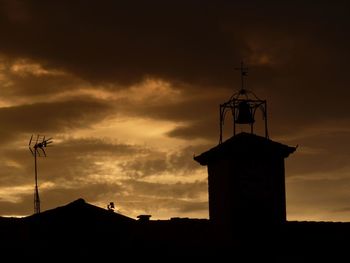 Low angle view of silhouette built structure against sky