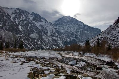 Scenic view of snow covered mountains against sky