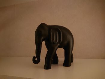 Close-up of elephant statue against wall