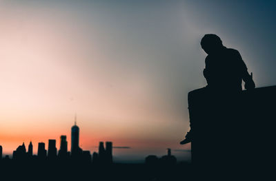 Silhouette of city at sunset