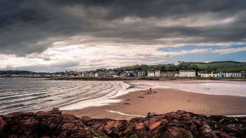 Scenic view of beach against sky in city