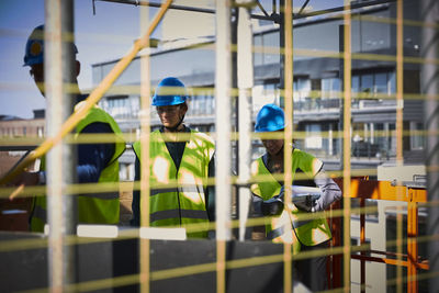 Male and female engineers in workwear at construction site