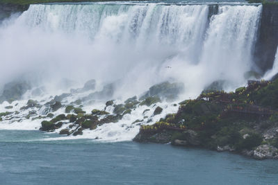 Scenic view of waterfall against sea