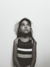 Portrait of young woman against white background