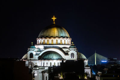 Illuminated building against sky at night
