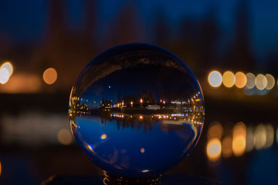 Reflection of illuminated lights in puddle