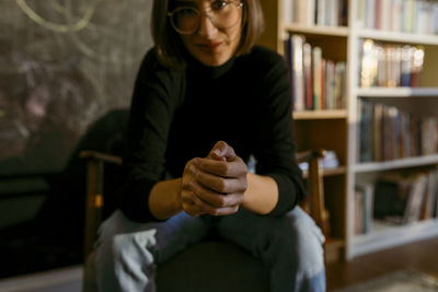 Young woman sitting on book