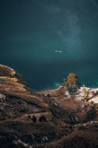 Scenic view of sea and mountain against sky