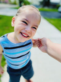 Close-up of smiling baby boy looking away