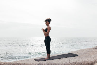 Full length of woman standing at beach