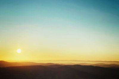 Scenic view of silhouette landscape against clear sky during sunset