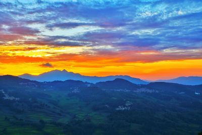 Scenic view of mountains against sky at sunset