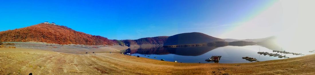Panoramic view of mountains against blue sky